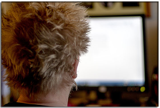 The back of Morgan Malone's head as she is writing on the computer